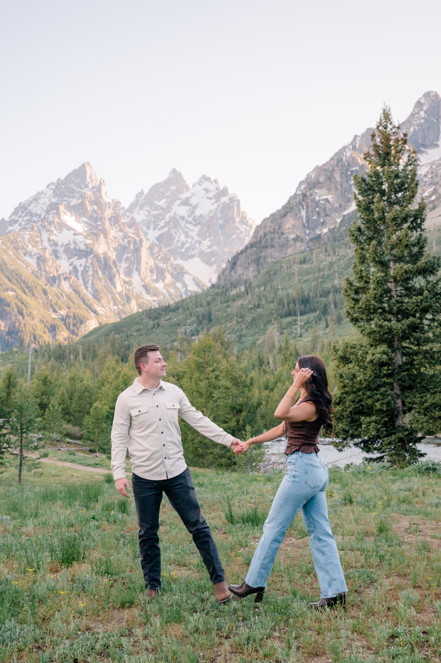 Michael and Brooke holding hands in the meadow